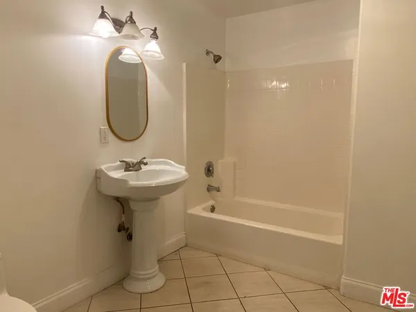 a bathroom with a sink a shower and a mirror
