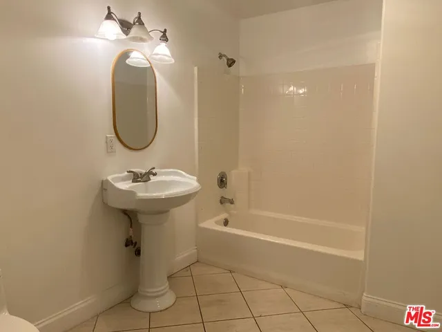 a bathroom with a sink a shower and a mirror