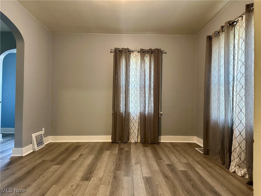 7954 Warren - Sharon Road Masury, OH 44438 - Photo 6 of 28 Spare room featuring arched walkways and wood finished floors