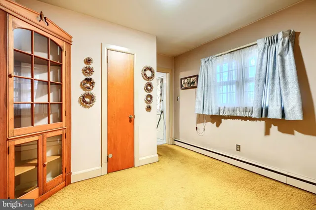 a view of a bedroom with wooden floor and stairs