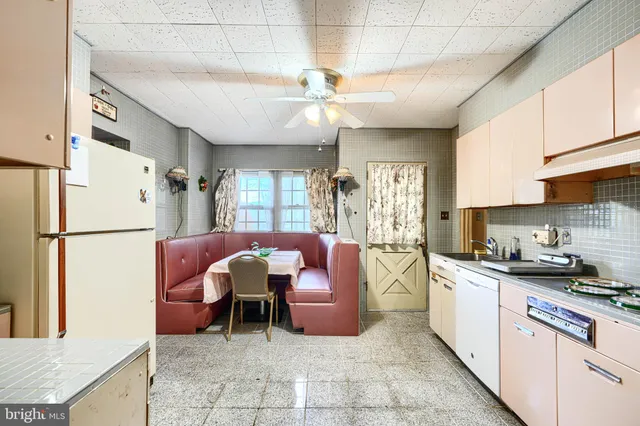 a view of a hallway with wooden floor and dining room