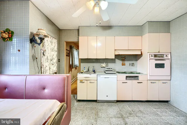 a bedroom with a bed and a flat tv screen on dresser