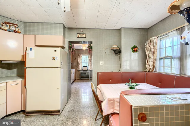 a bedroom with a bed and large windows