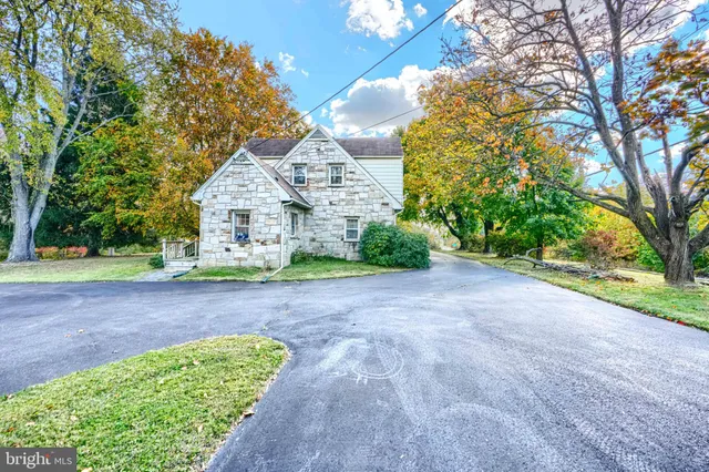 a front view of a house with a garden and yard