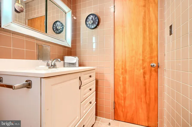 a bedroom with a bed window and mirror