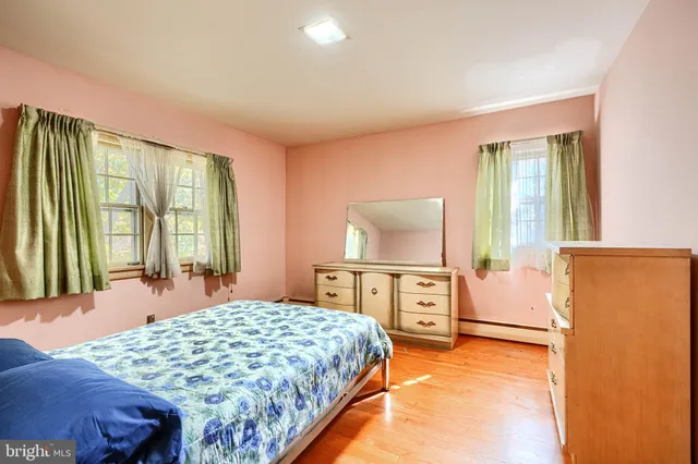 a bedroom with furniture and large windows