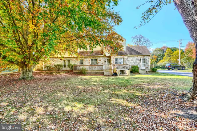 a house view with swimming pool and porch