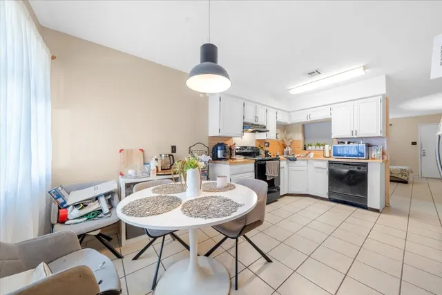a open kitchen with stainless steel appliances kitchen island granite countertop a sink and cabinets