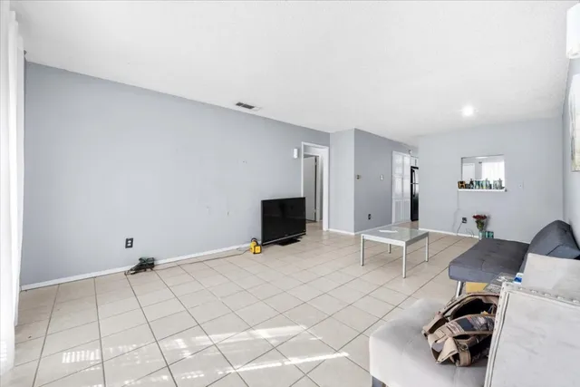 a view of a livingroom with lounge chair and a fireplace