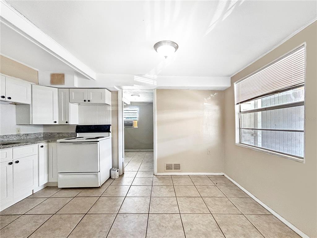 6308 20th Street Zephyrhills, FL 33542 - Photo 14 of 19 a kitchen with a stove a sink and a refrigerator