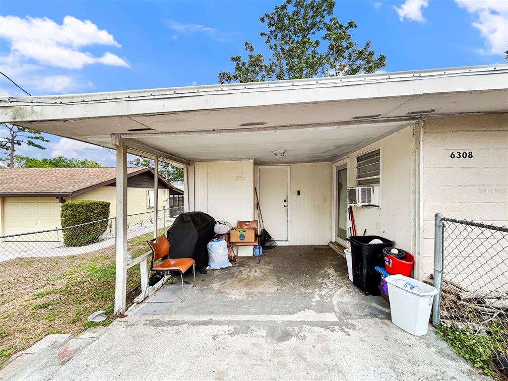 6308 20th Street Zephyrhills, FL 33542 - Photo 2 of 19 a view of a patio with table and chairs potted plants