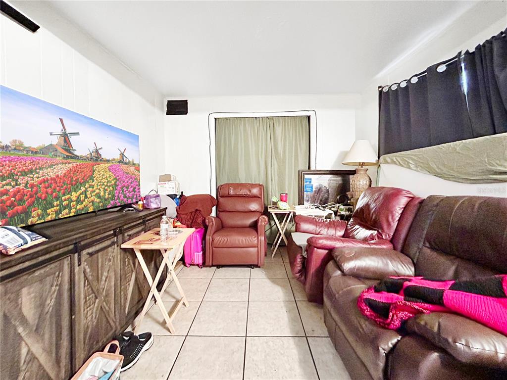 6308 20th Street Zephyrhills, FL 33542 - Photo 3 of 19 a living room with furniture and a flat screen tv