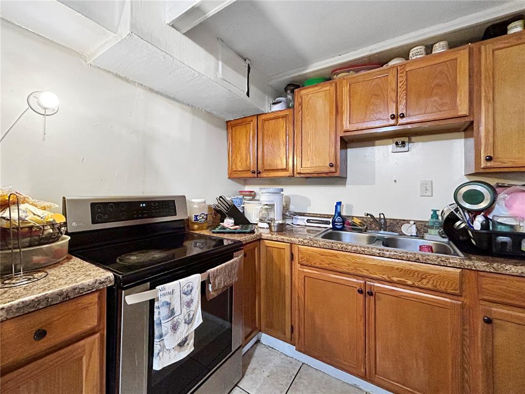 6308 20th Street Zephyrhills, FL 33542 - Photo 5 of 19 a kitchen with stainless steel appliances granite countertop a stove sink and cabinets