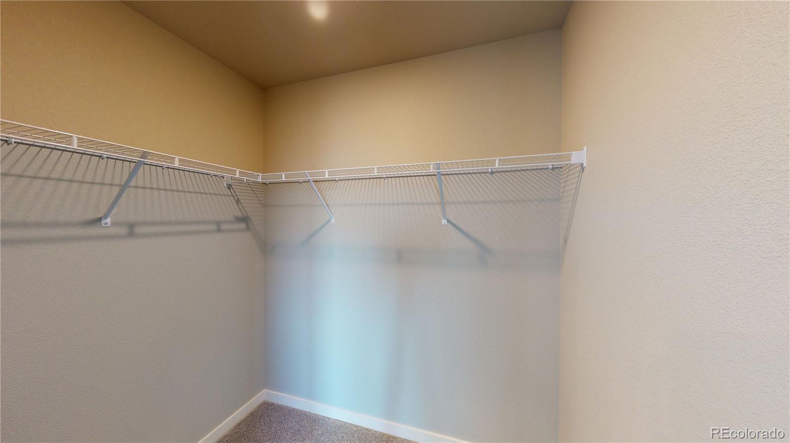 1353 Reynolds Street, Unit 9B Fort Lupton, CO 80621 - Photo 12 of 14 a view of a room with racks on the wall