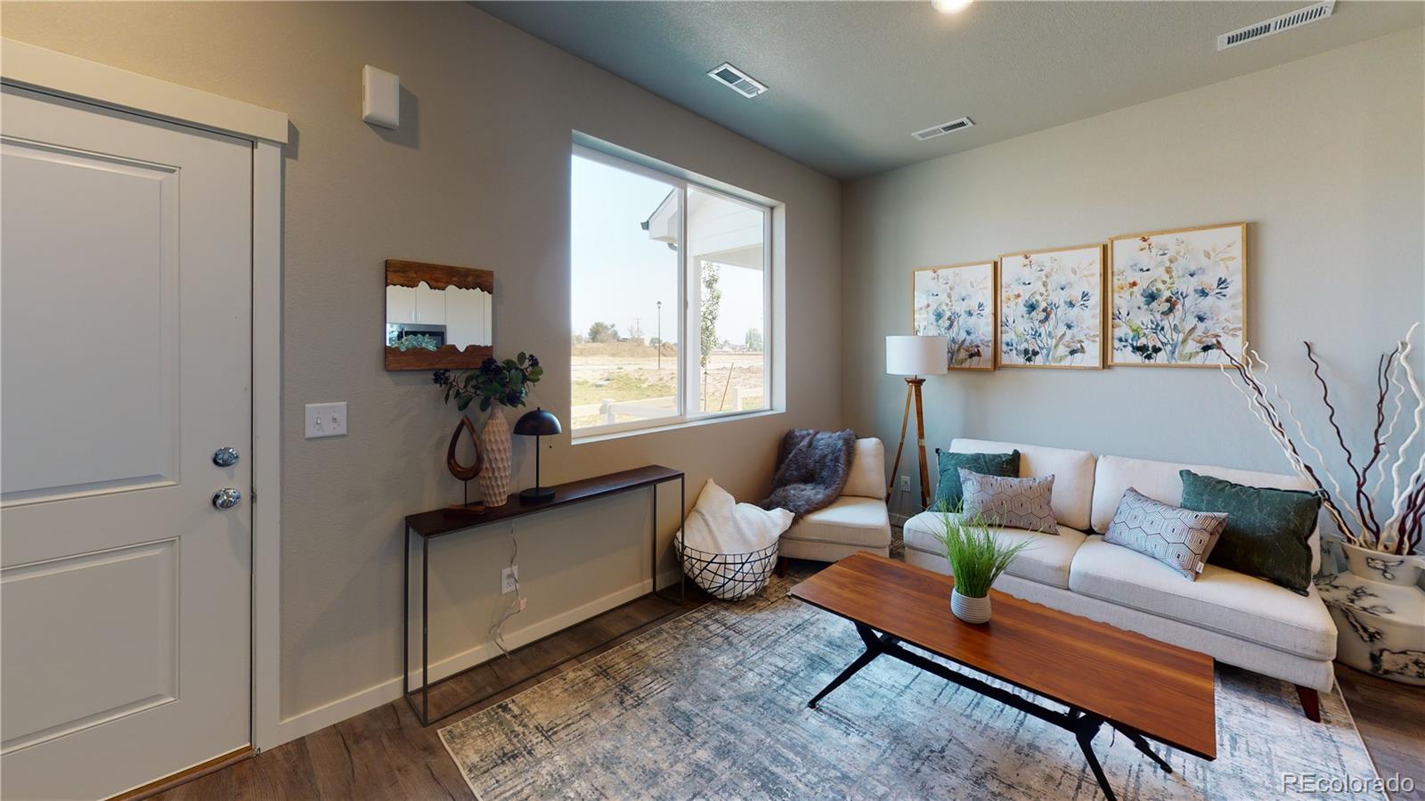 1353 Reynolds Street, Unit 9B Fort Lupton, CO 80621 - Photo 3 of 14 a living room with furniture and a window