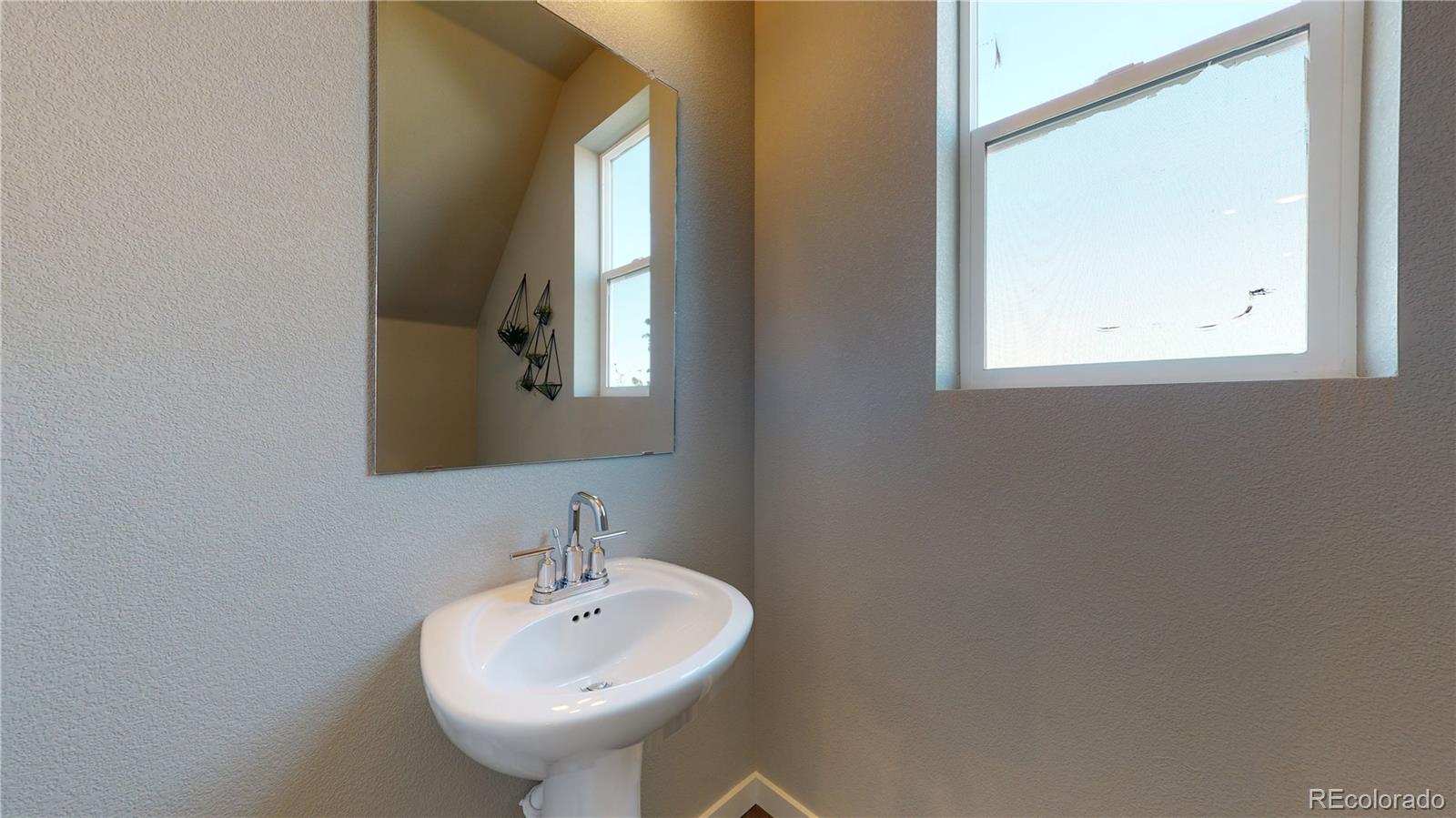 1353 Reynolds Street, Unit 9B Fort Lupton, CO 80621 - Photo 8 of 14 a bathroom with a sink and a mirror