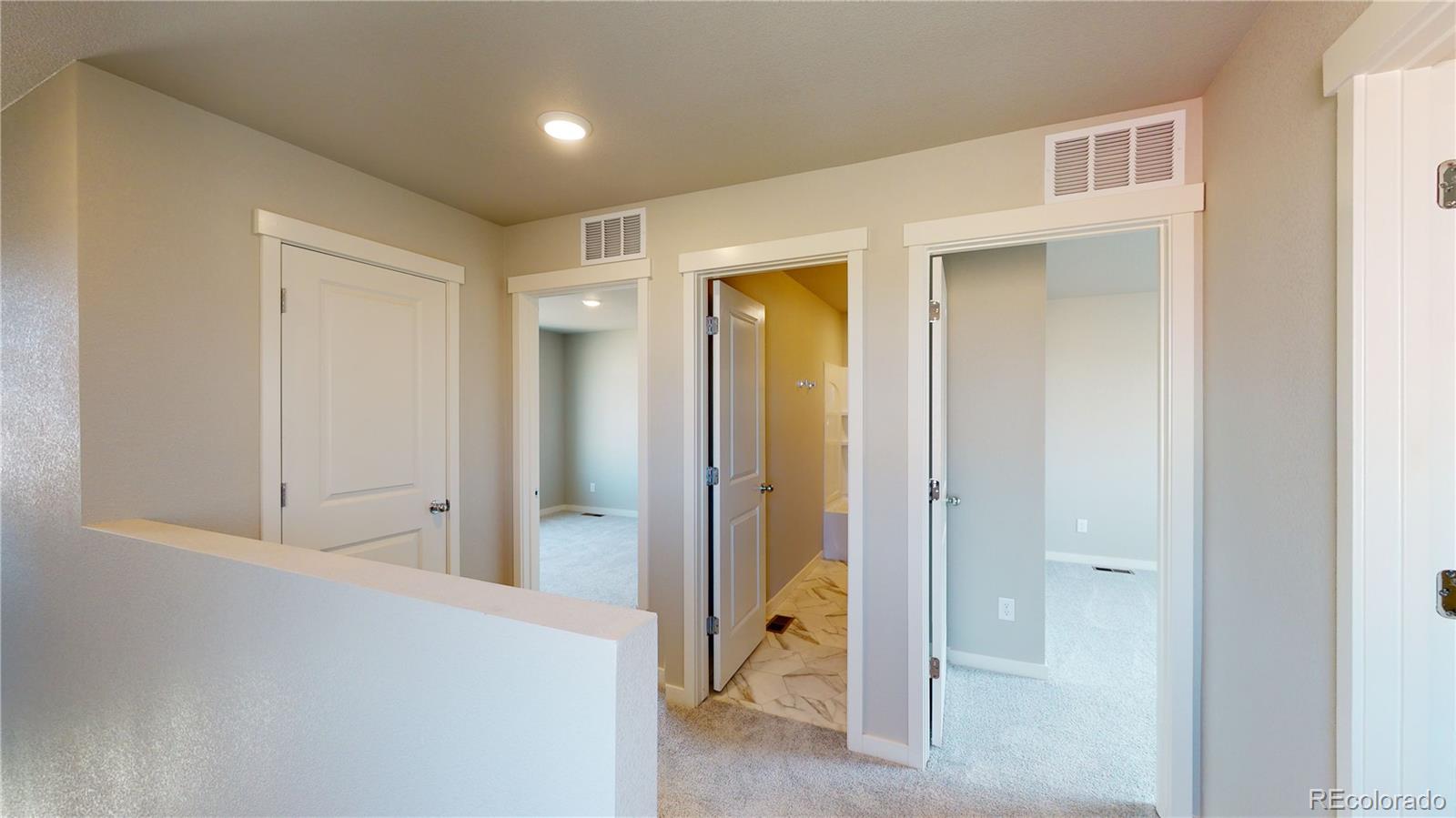 1353 Reynolds Street, Unit 9B Fort Lupton, CO 80621 - Photo 9 of 14 a view of a hallway with closet and bathroom