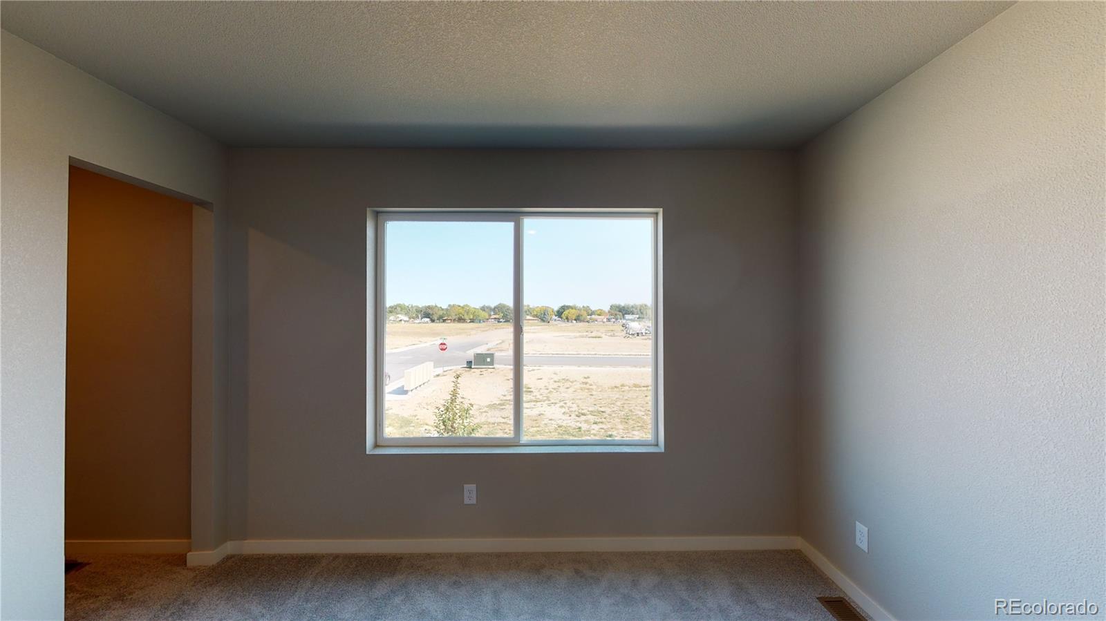 1353 Reynolds Street, Unit 9B Fort Lupton, CO 80621 - Photo 10 of 14 an empty room with a window