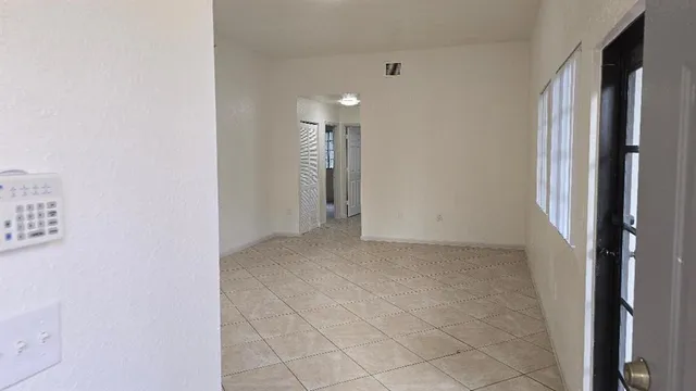 a view of hallway with a bathroom