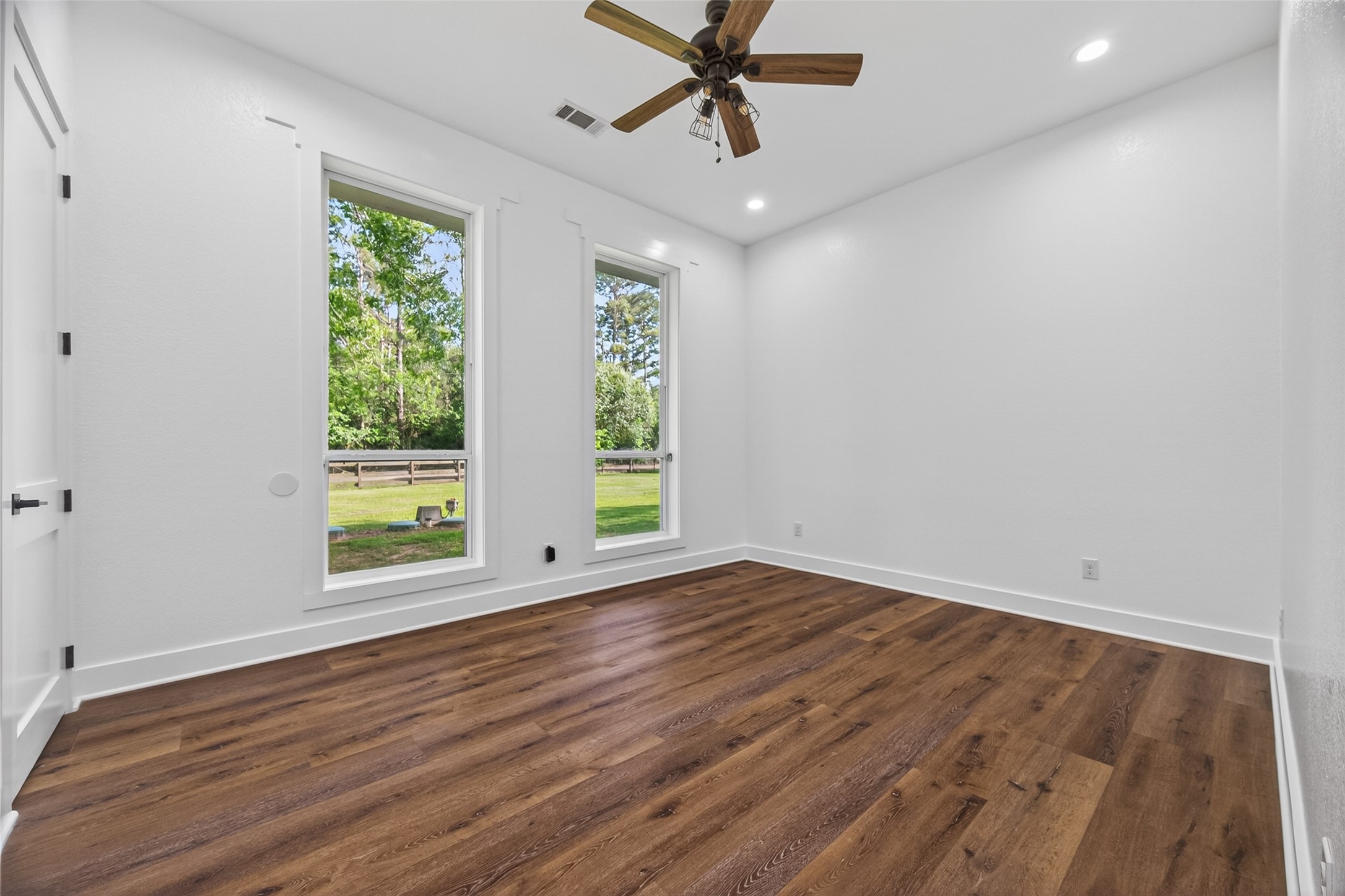 12625 Padon Road Needville, TX 77461 - Photo 12 of 50 Bright and spacious bedroom with large windows, abundant natural light, and peaceful views of the surrounding greenery.