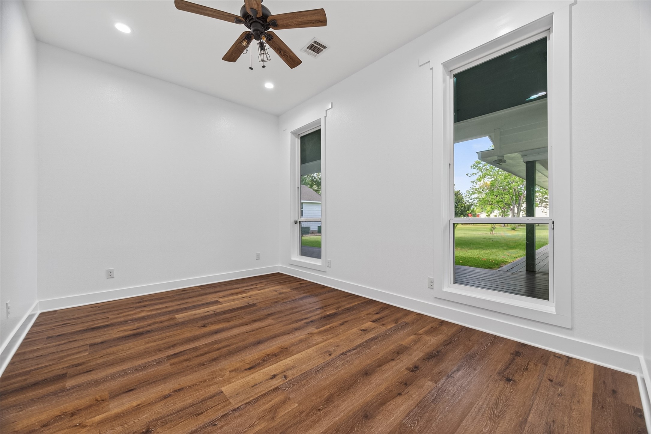 12625 Padon Road Needville, TX 77461 - Photo 14 of 50 Bright and spacious bedroom with large windows, abundant natural light, and peaceful views of the surrounding greenery.