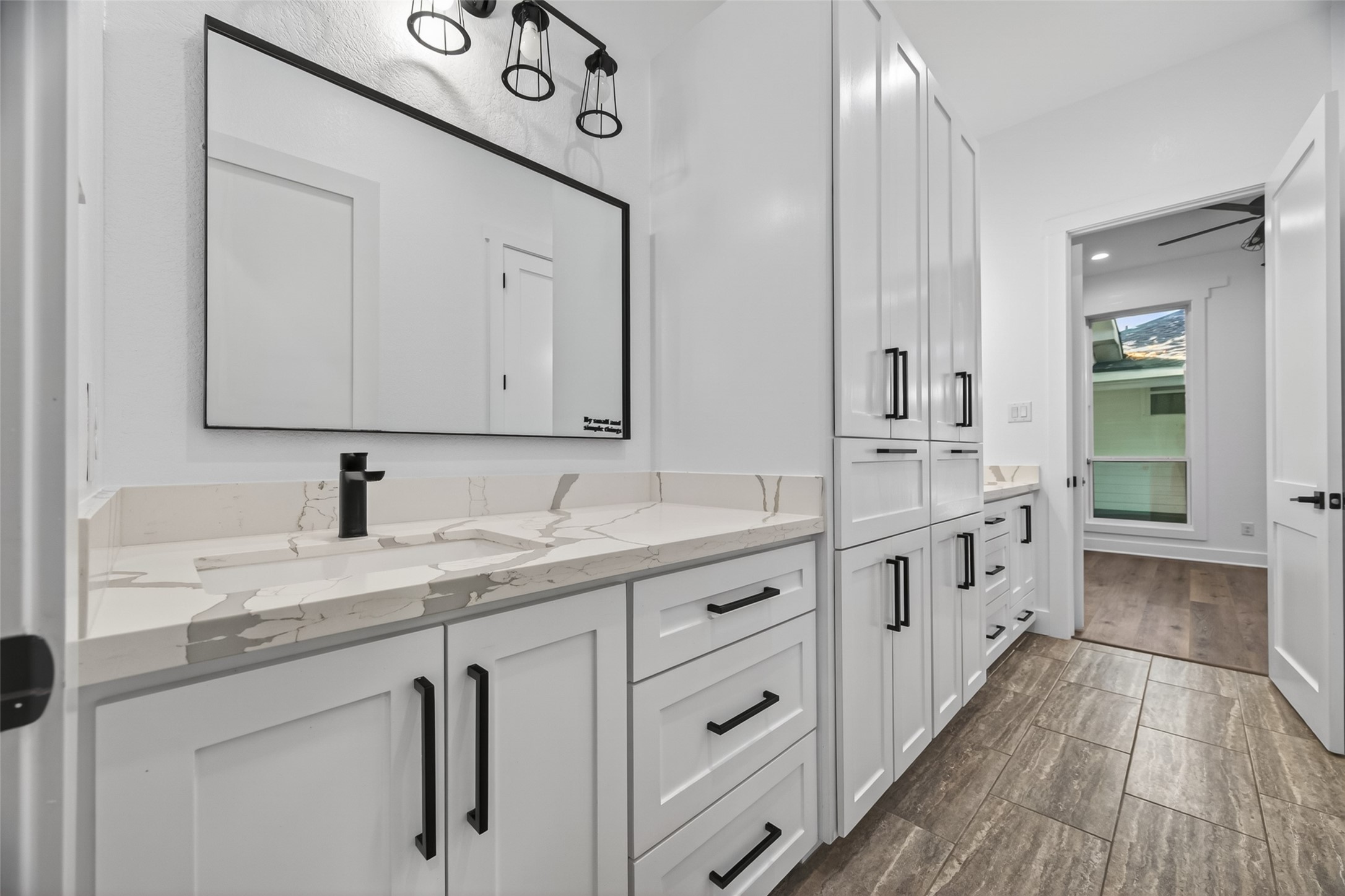 12625 Padon Road Needville, TX 77461 - Photo 21 of 50 Elegant bathroom with sleek vanity, quartz countertops, and abundant custom cabinetry for exceptional storage and organization.