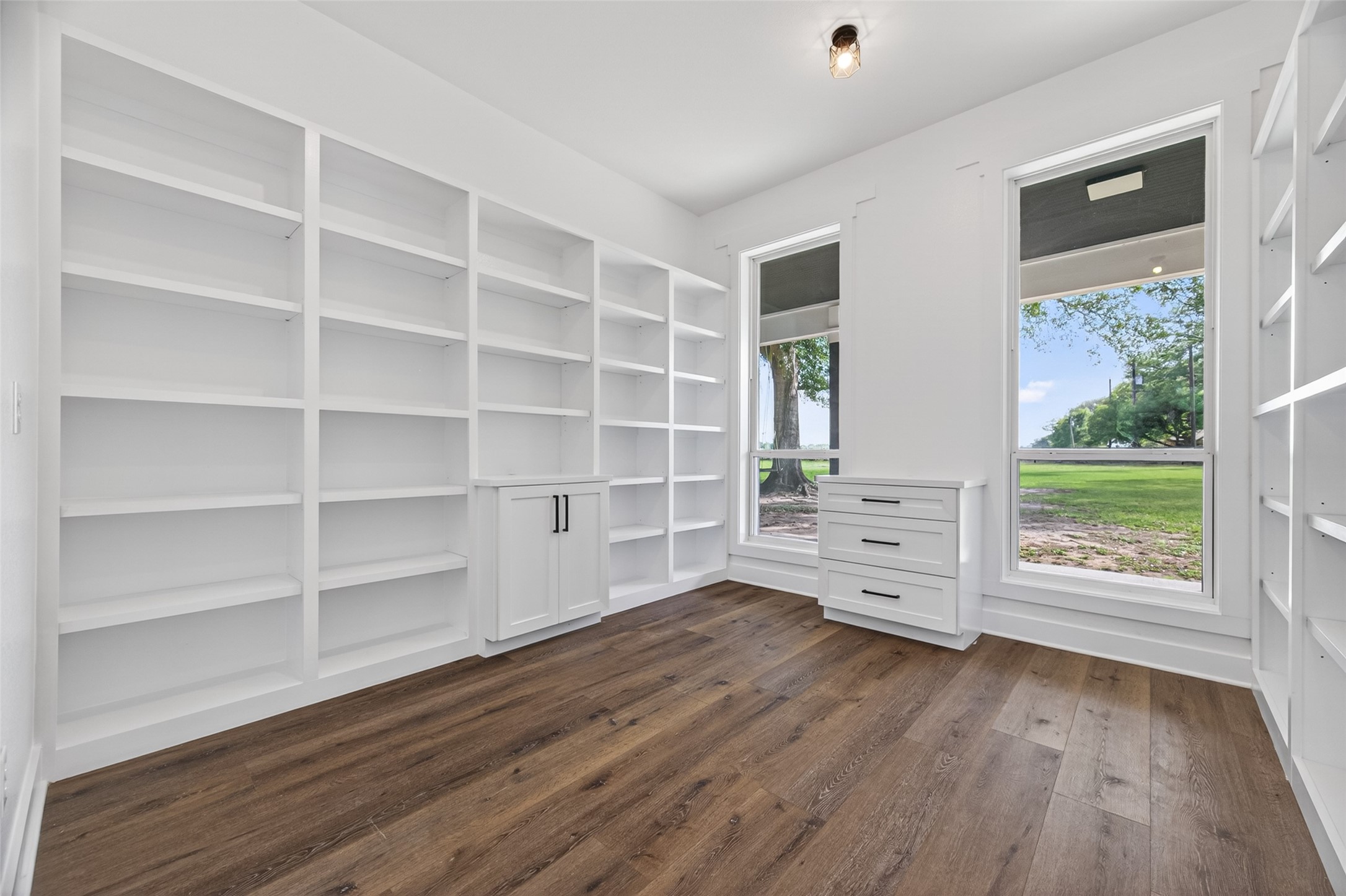 12625 Padon Road Needville, TX 77461 - Photo 24 of 50 Fully customized walk-in pantry with extensive built-in shelving and abundant natural light, offering exceptional storage and organization.