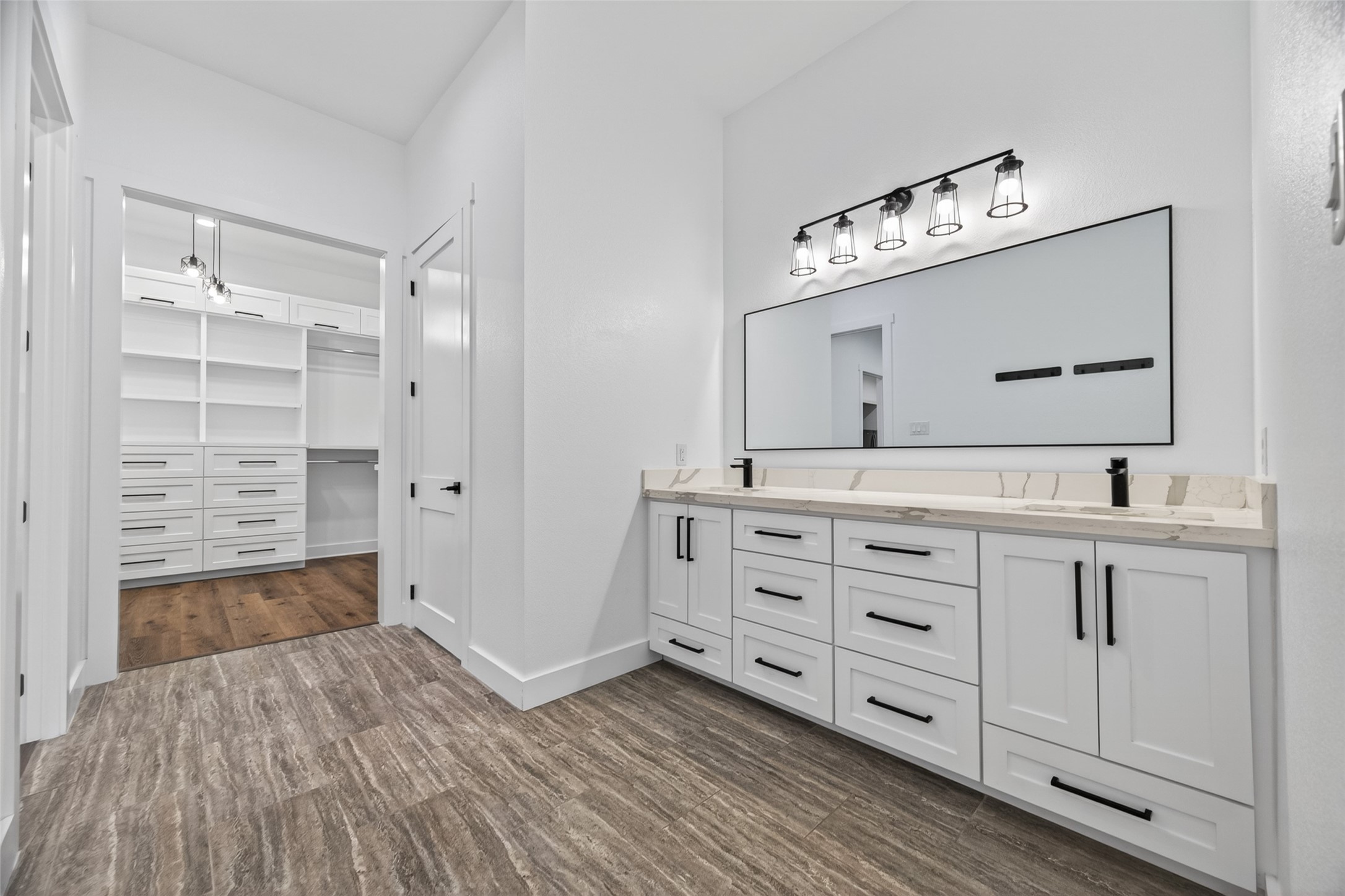 12625 Padon Road Needville, TX 77461 - Photo 30 of 50 Spacious primary bathroom with dual vanities and modern finishes, seamlessly connected to the primary bedroom and a fully custom-designed walk-in closet.