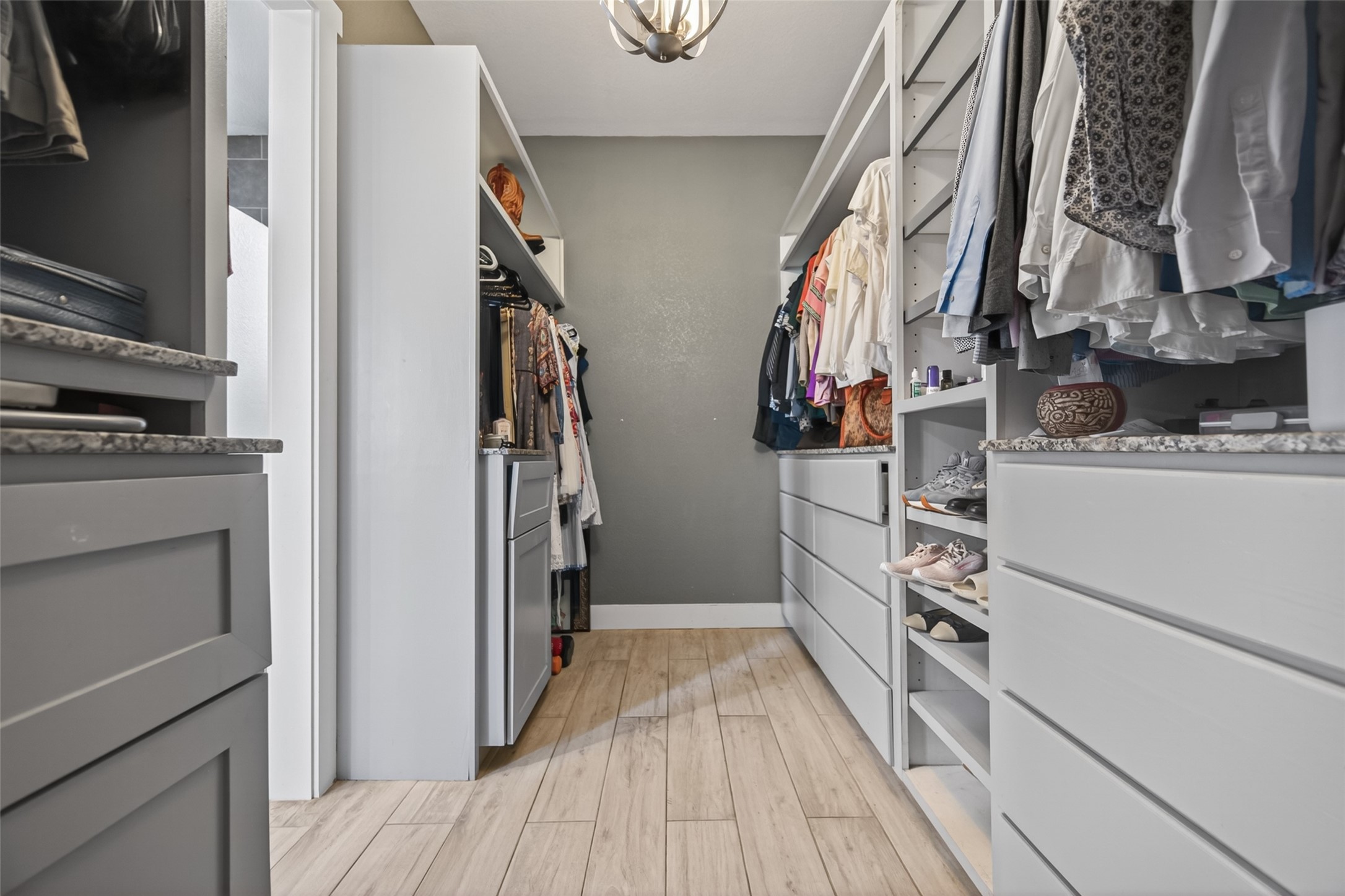 12625 Padon Road Needville, TX 77461 - Photo 39 of 50 Spacious walk-in closet in the guest house featuring custom-built cabinetry, drawers, and shelving for organized and efficient storage.