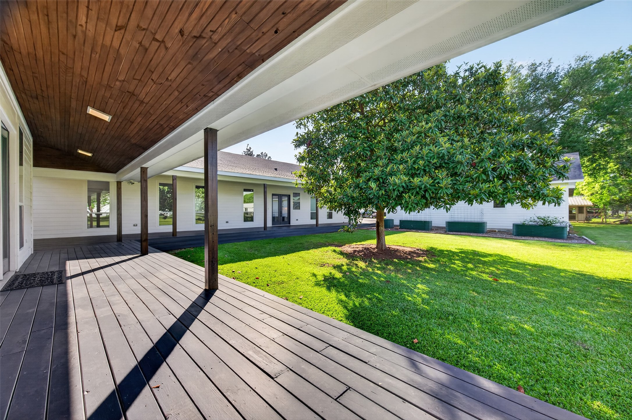 12625 Padon Road Needville, TX 77461 - Photo 41 of 50 Large wooden deck connecting the main home to the private guest suite.
