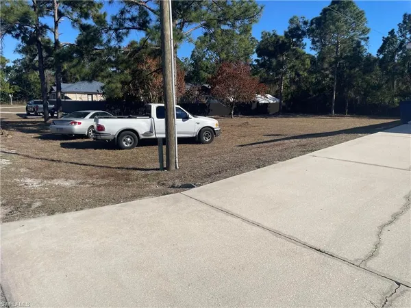 a view of street with parked cars