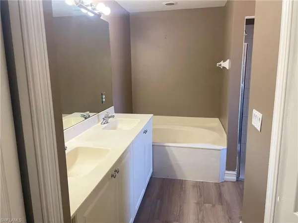 a bathroom with a bathtub and shower