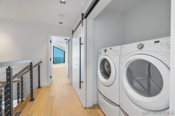 a view of a hallway with washer and dryer