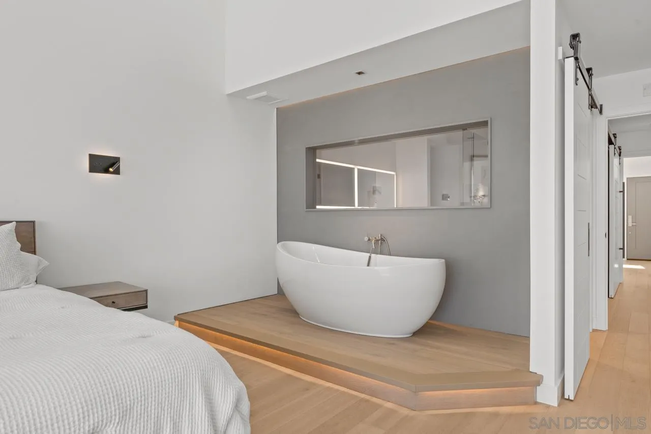 135 South Sierra Avenue, Unit 32 Solana Beach, CA 92075 - Photo 14 of 27 a spacious bedroom with a bed and a white wall