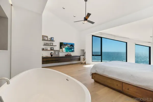 a bedroom with a bed and large mirror