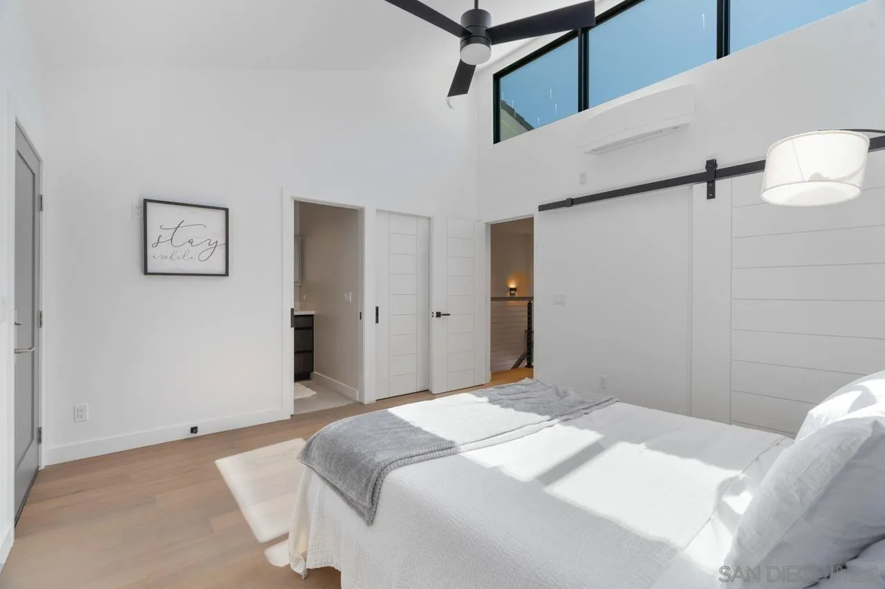 135 South Sierra Avenue, Unit 32 Solana Beach, CA 92075 - Photo 17 of 27 a bedroom with a bed and a painting on the wall