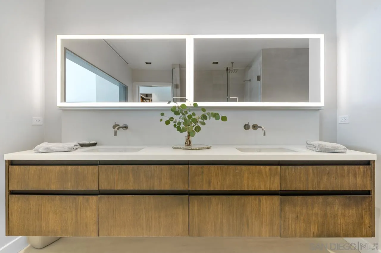 135 South Sierra Avenue, Unit 32 Solana Beach, CA 92075 - Photo 18 of 27 a bathroom with a sink and a mirror