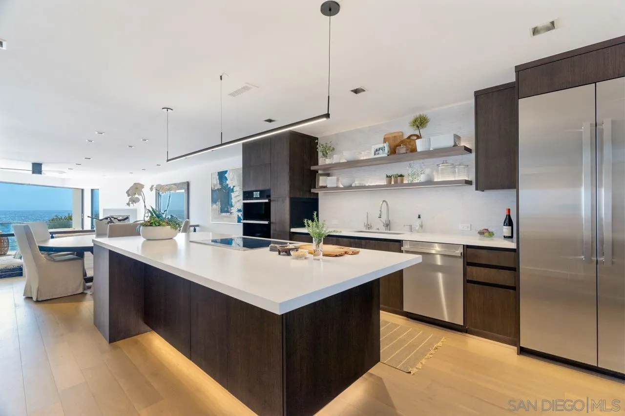 135 South Sierra Avenue, Unit 32 Solana Beach, CA 92075 - Photo 5 of 27 a kitchen with cabinets a sink and stainless steel appliances