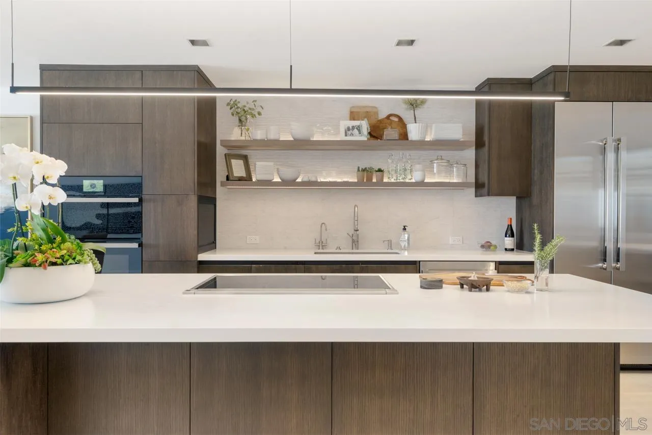 135 South Sierra Avenue, Unit 32 Solana Beach, CA 92075 - Photo 6 of 27 a kitchen with a sink and a refrigerator