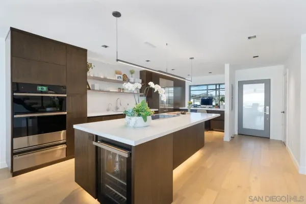 a kitchen with a sink and stainless steel appliances