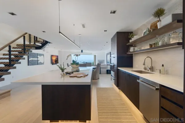 a kitchen with stainless steel appliances sink stove and cabinets