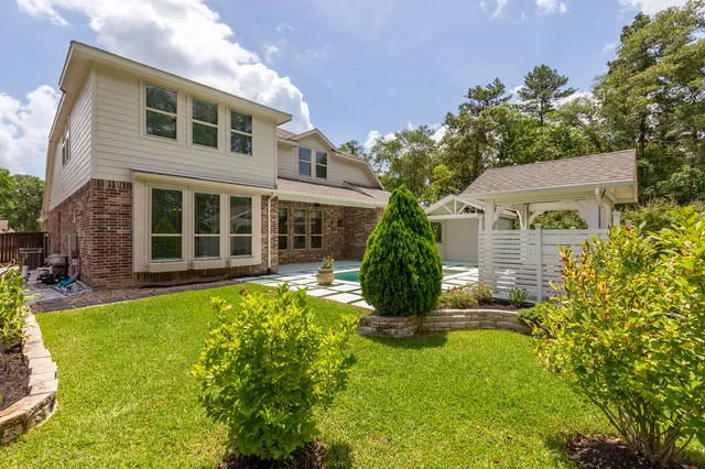 a view of house with yard and sitting area