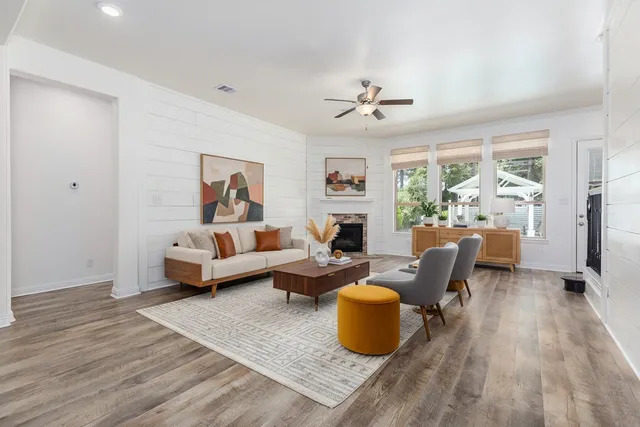a living room with furniture window and wooden floor