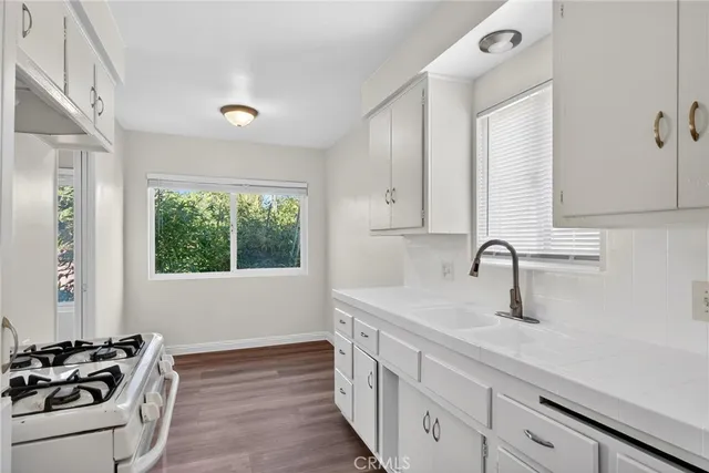 a kitchen that has a sink and a stove