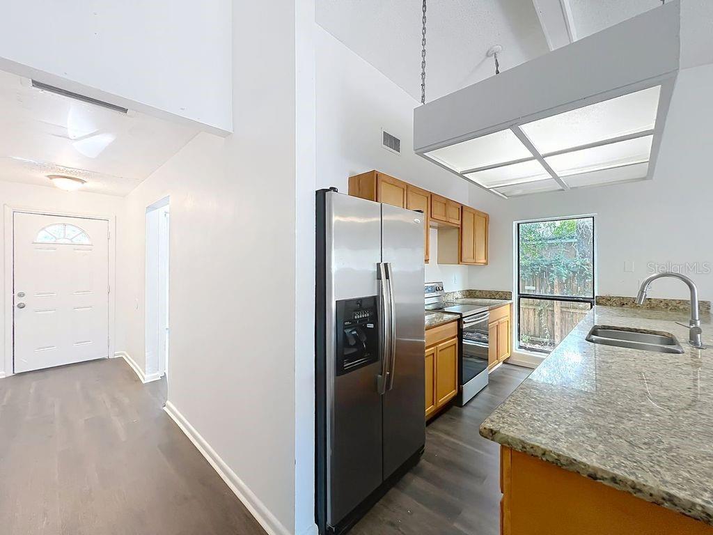 5214 2nd Street Orlando, FL 32810 - Photo 11 of 50 a kitchen with stainless steel appliances granite countertop a refrigerator and a sink