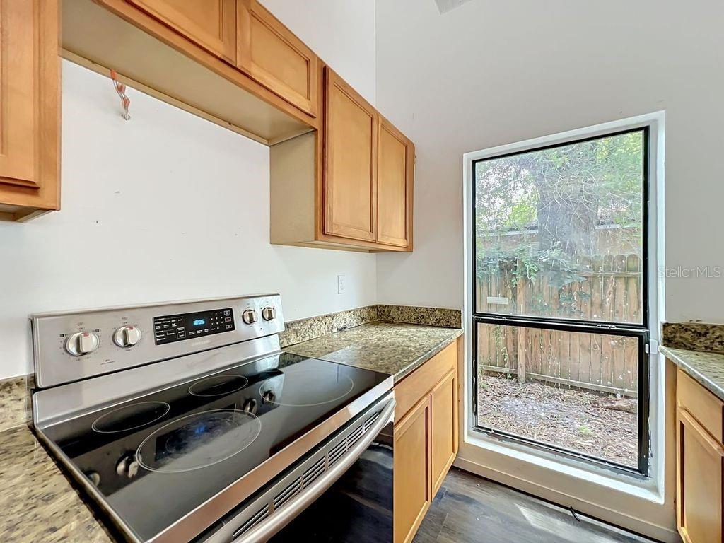 5214 2nd Street Orlando, FL 32810 - Photo 13 of 50 a kitchen with a stove and a microwave