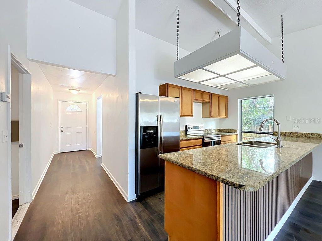 5214 2nd Street Orlando, FL 32810 - Photo 17 of 50 a kitchen with stainless steel appliances granite countertop a sink a counter space and wooden floor
