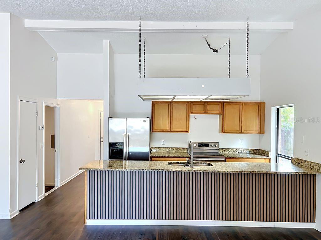 5214 2nd Street Orlando, FL 32810 - Photo 20 of 50 a kitchen with stainless steel appliances granite countertop a sink and a granite counter tops