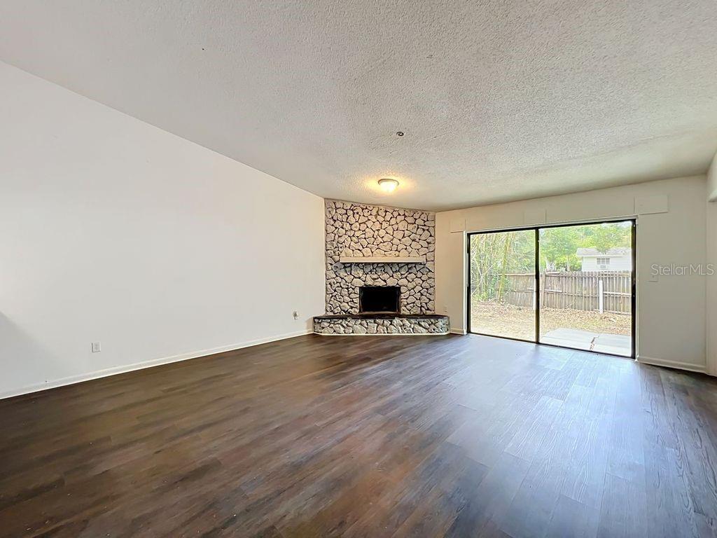 5214 2nd Street Orlando, FL 32810 - Photo 21 of 50 an empty room with wooden floor and fireplace
