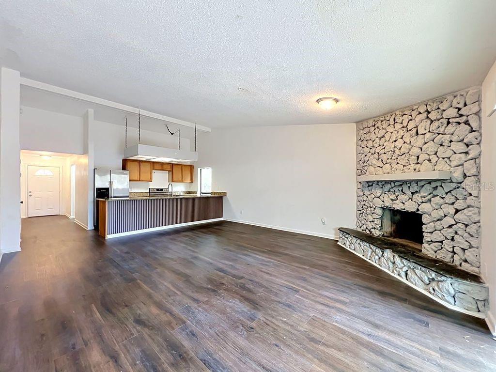 5214 2nd Street Orlando, FL 32810 - Photo 25 of 50 a living room with stainless steel appliances furniture a fireplace and wooden floor